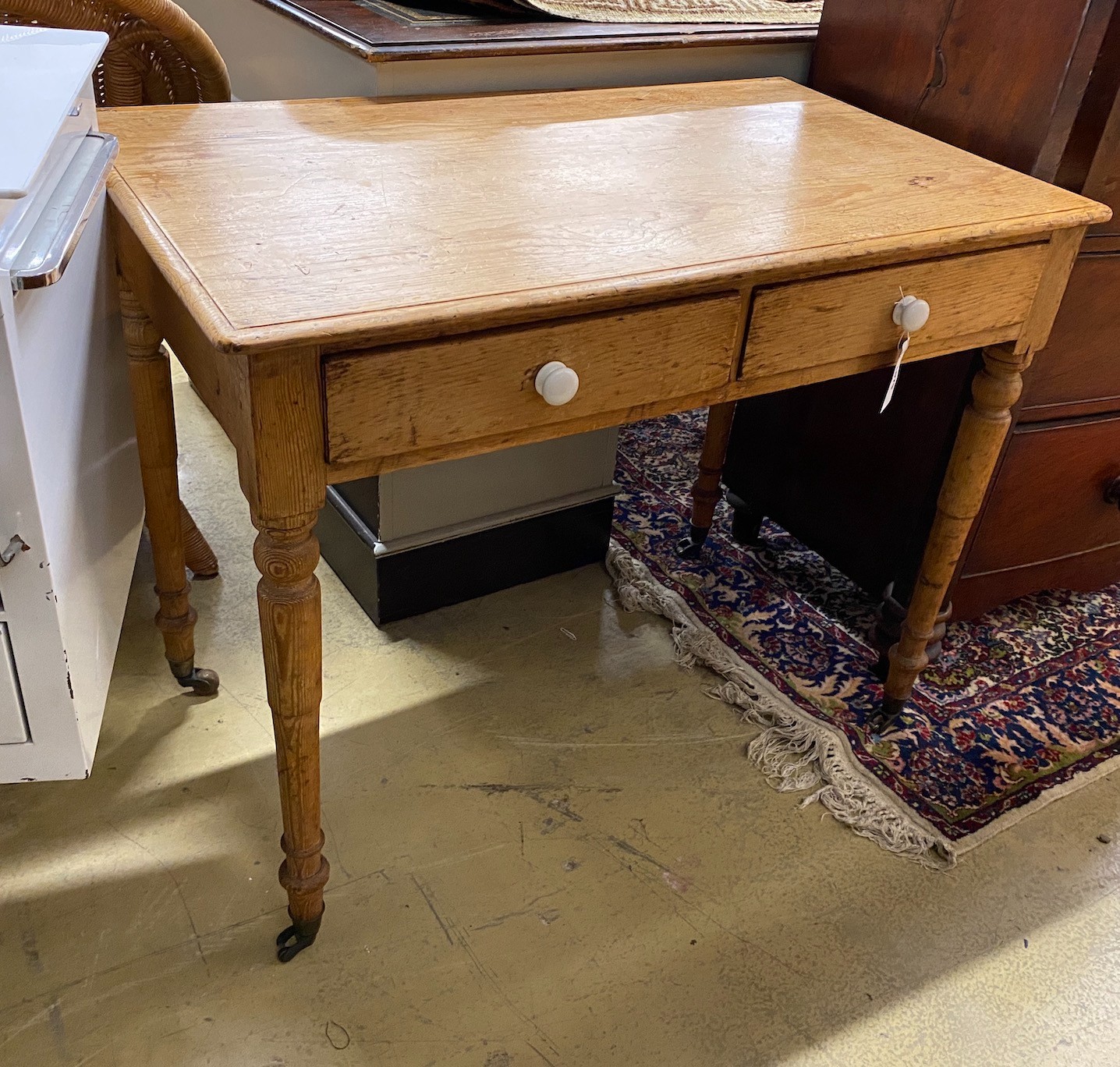 A late Victorian pine two drawer side table, width 92cm, height 74cm